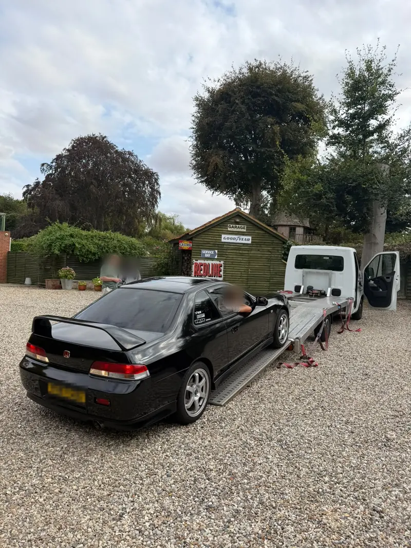 Black Honda Prelude driving up the low-angle ramps onto the BHR recovery truck