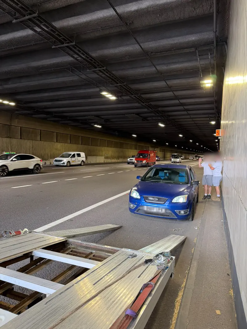 BHR recovery truck with its ramps down behind a broken-down blue Ford Focus ST in a motorway tunnel